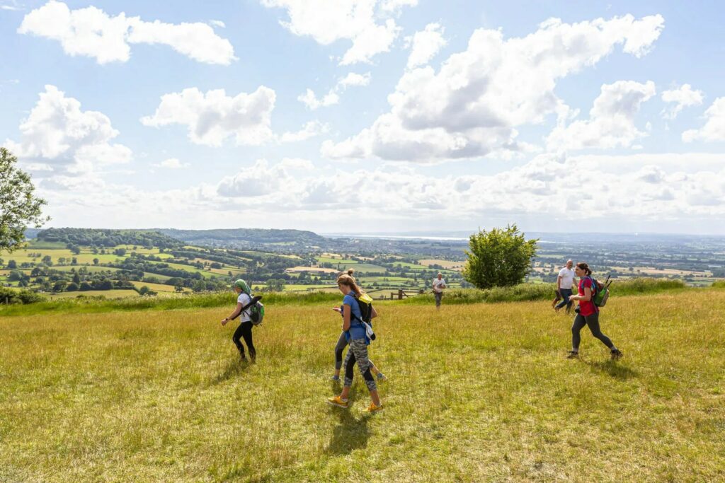 Walkers on the route of the Peak District Challenge, with a stunning backdrop.