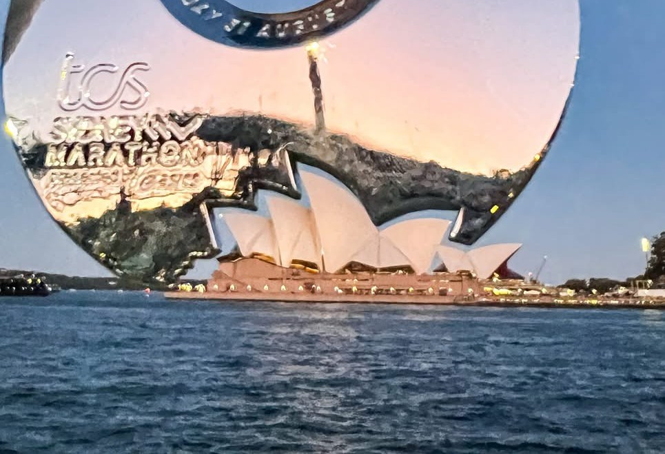 The Sydney Marathon medal with the outline of the Sydney Opera House, held perfectly in place with the original.
