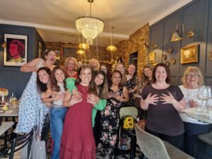 Ellie and her friends/family at her 'Boob Party'. Most are holding their chests.