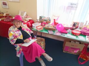 Jess's mum sat in front of the raffle at her event.