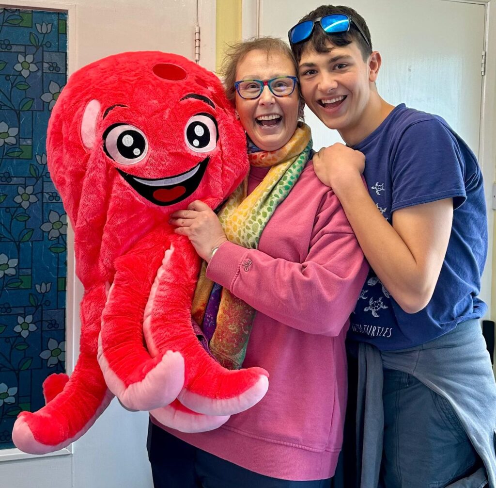 Jess, holding a red cuddly octopus, and her son Noah at her breast cancer fundraising event