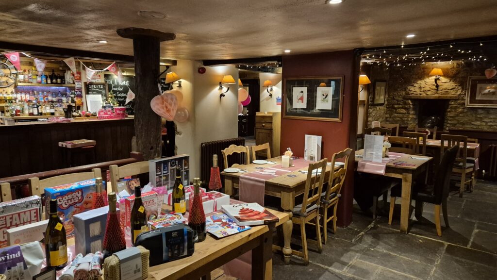 Raffle prizes and tables all laid out before the Pubs in Pink event at the Merry Miller