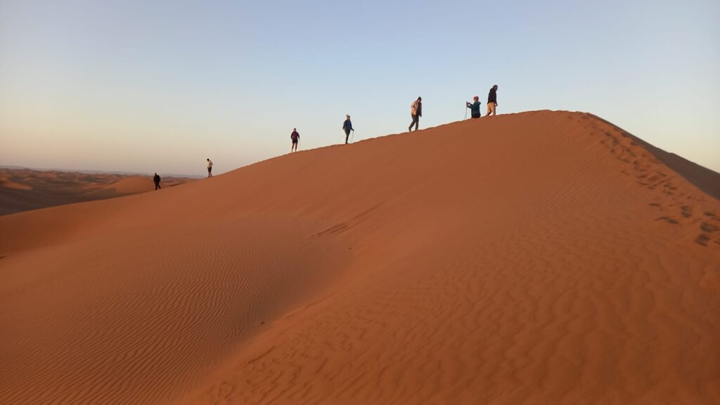 A fabulous wide view from Lee and the trekkers climbing a sand dune in the Sahara Desert.