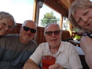 Four people with Mike second to right holding a pint.