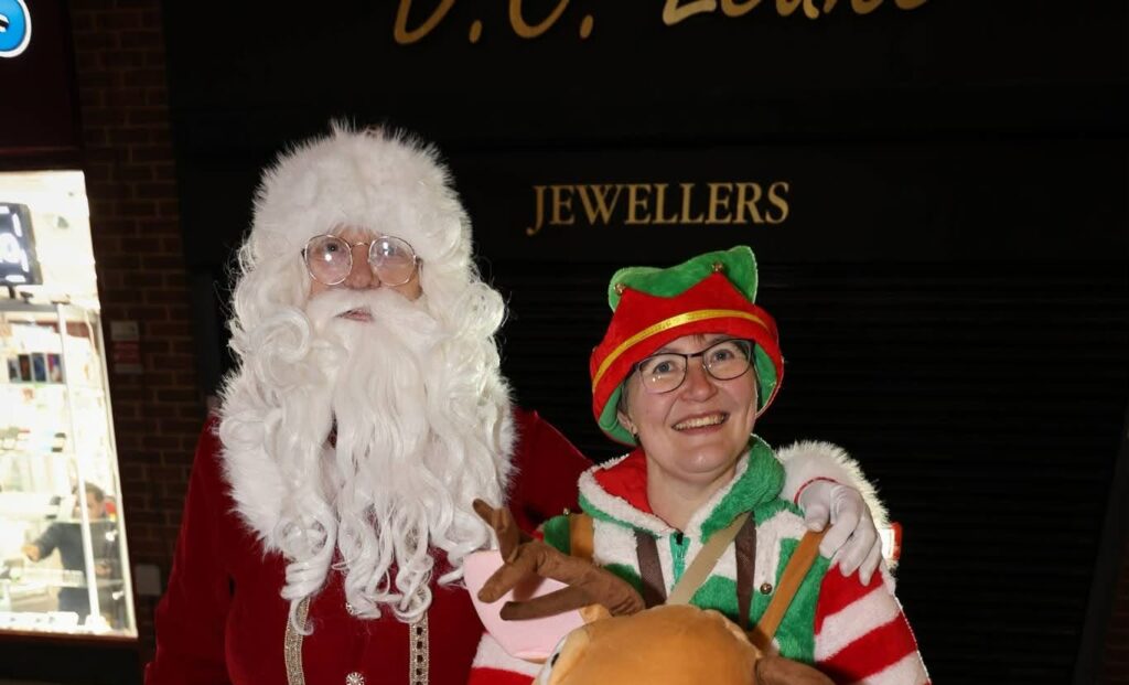 Brian dressed as Santa and Sarah as one of his elves
