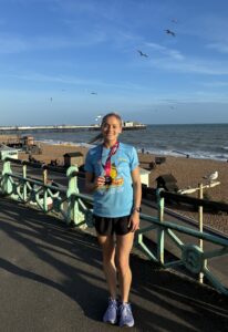 Abi Barrett with her Brighton Marathon medal on the seafront